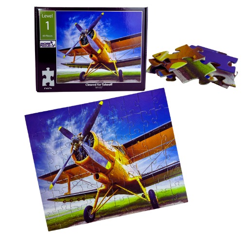 Jigsaw puzzle with a yellow airplane on a blue sky background, showing completed pieces and packaging.